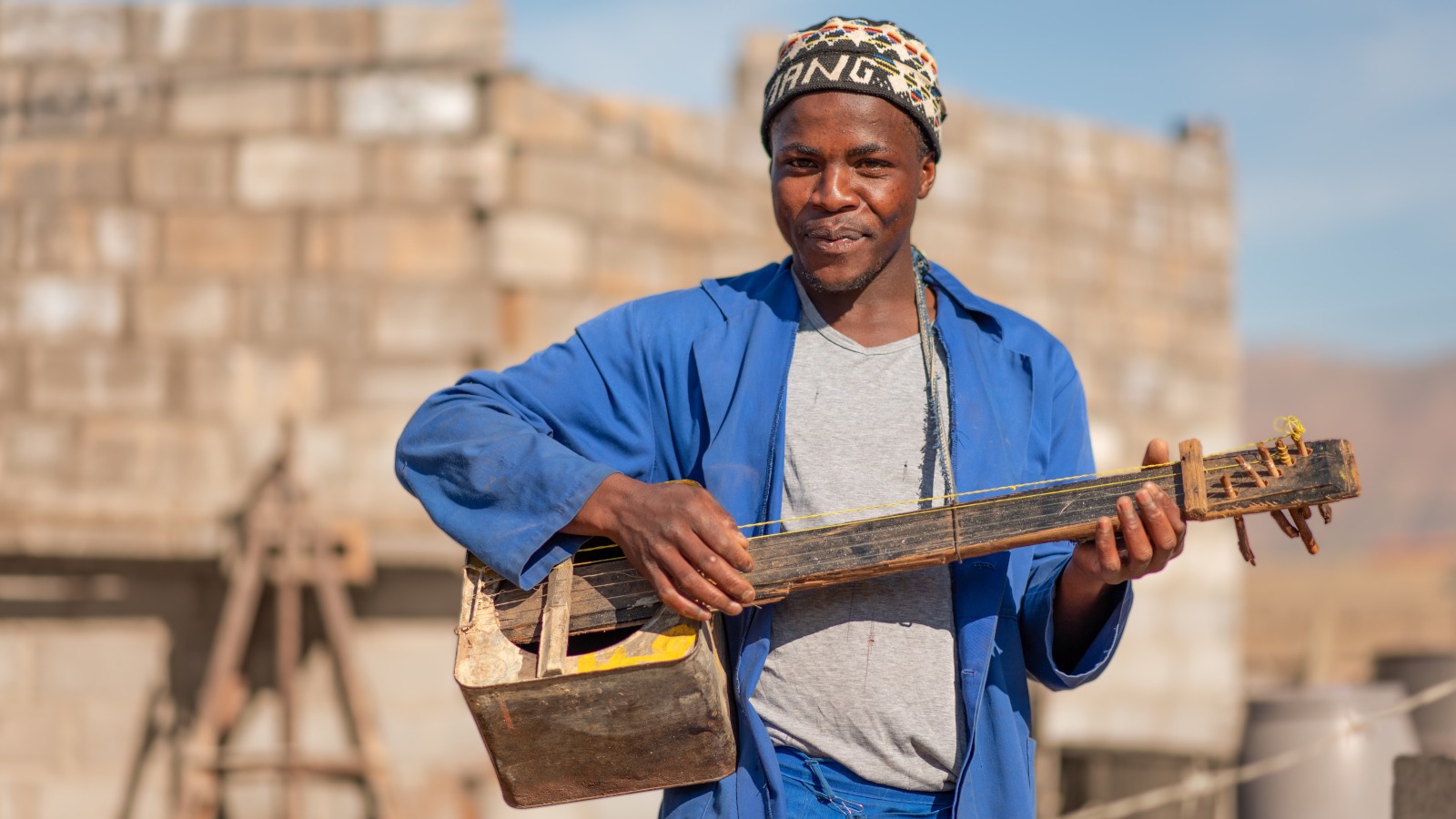A man poses with his homemade guitar in lesotho